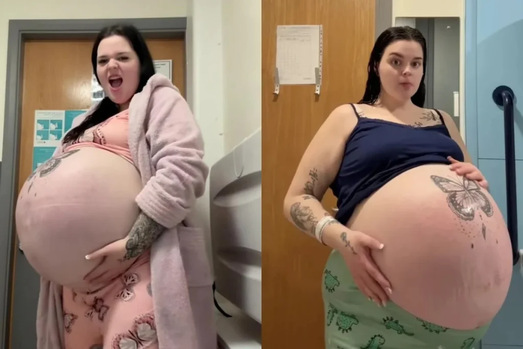 Pregnant woman with a large belly, showcasing tattoos, in casual clothing and a hospital setting.